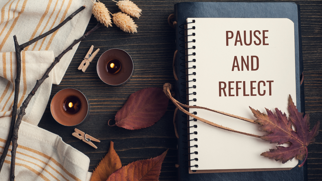 Pause and reflect – open journal with pen, surrounded by calming aromatherapy essentials for mindful journaling.