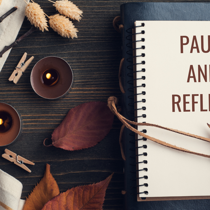 Pause and reflect – open journal with pen, surrounded by calming aromatherapy essentials for mindful journaling.